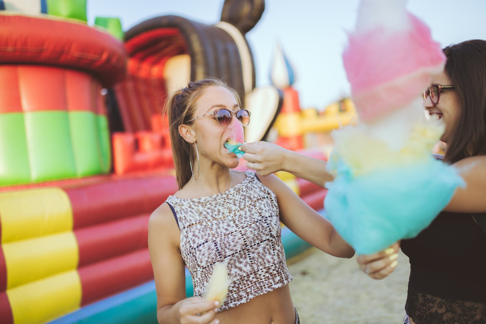 Girls eating cotton candy at the county fair