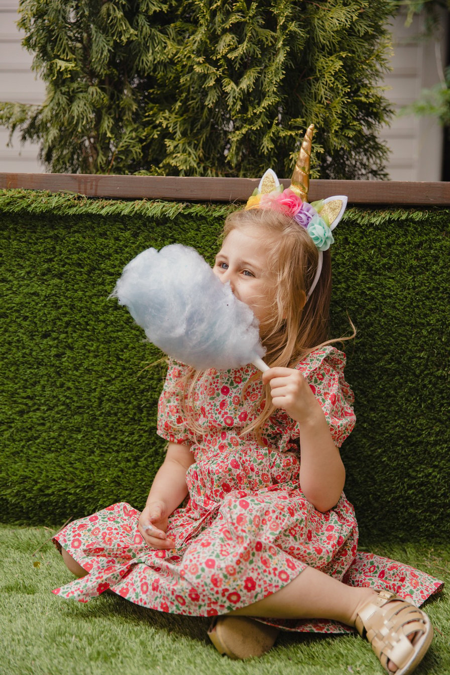 Cite Girl Eating Cotton Candy